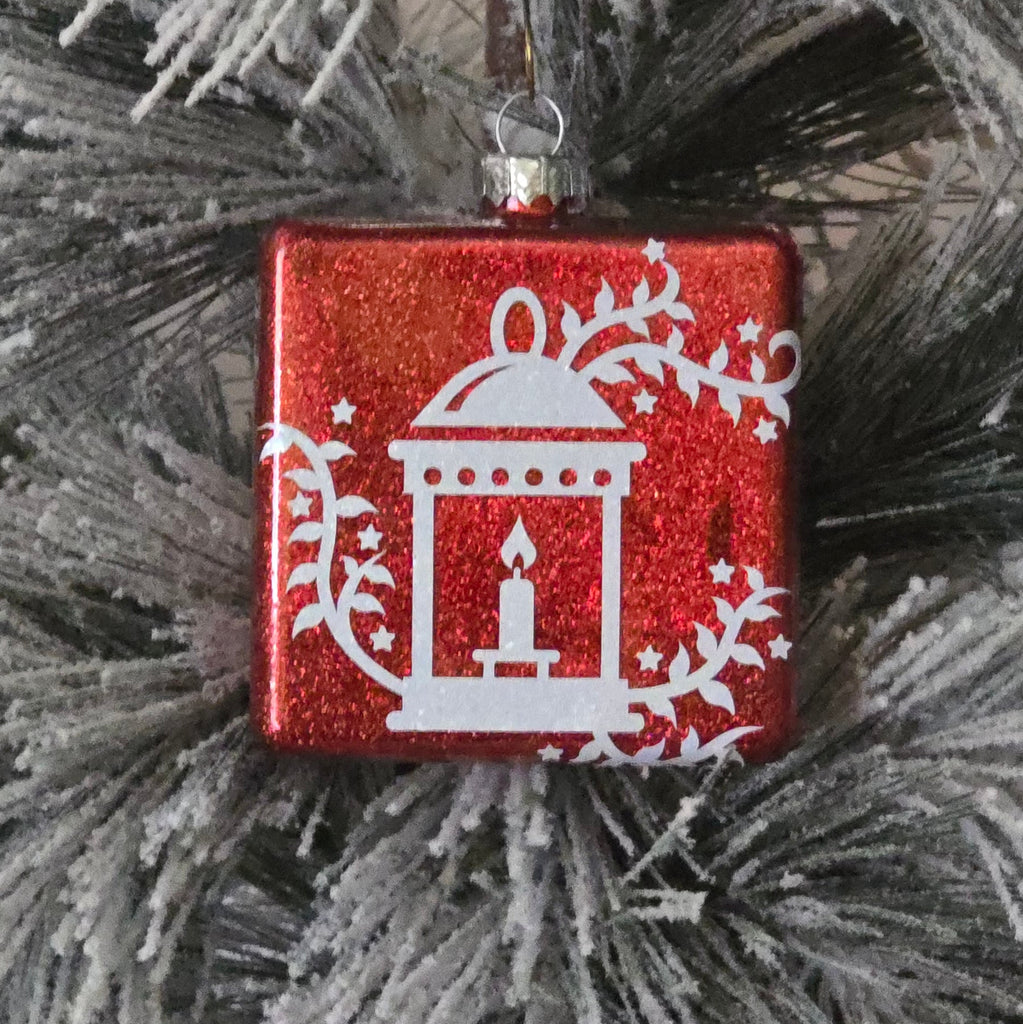 Red Christmas ornament with white  lantern design