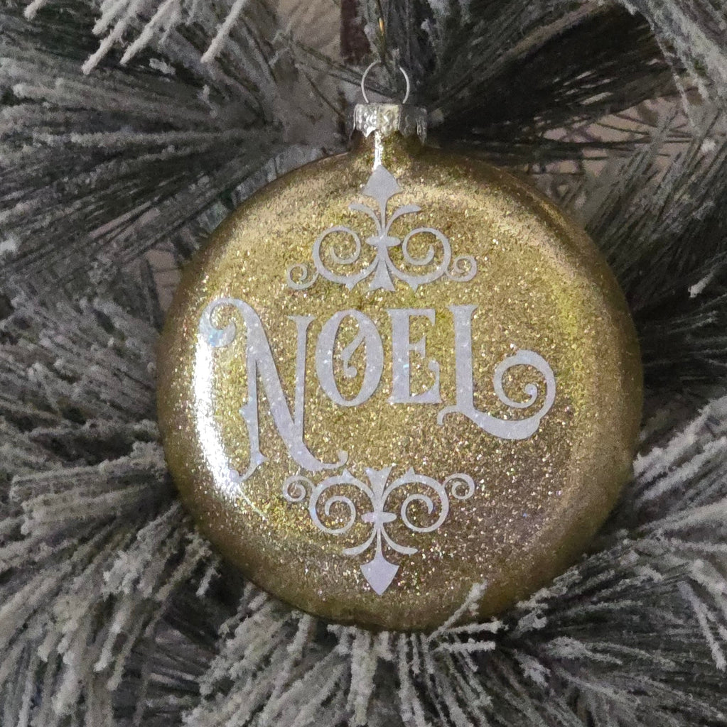 Decorative Christmas ornament with 'Noel' text on a frosted branch background