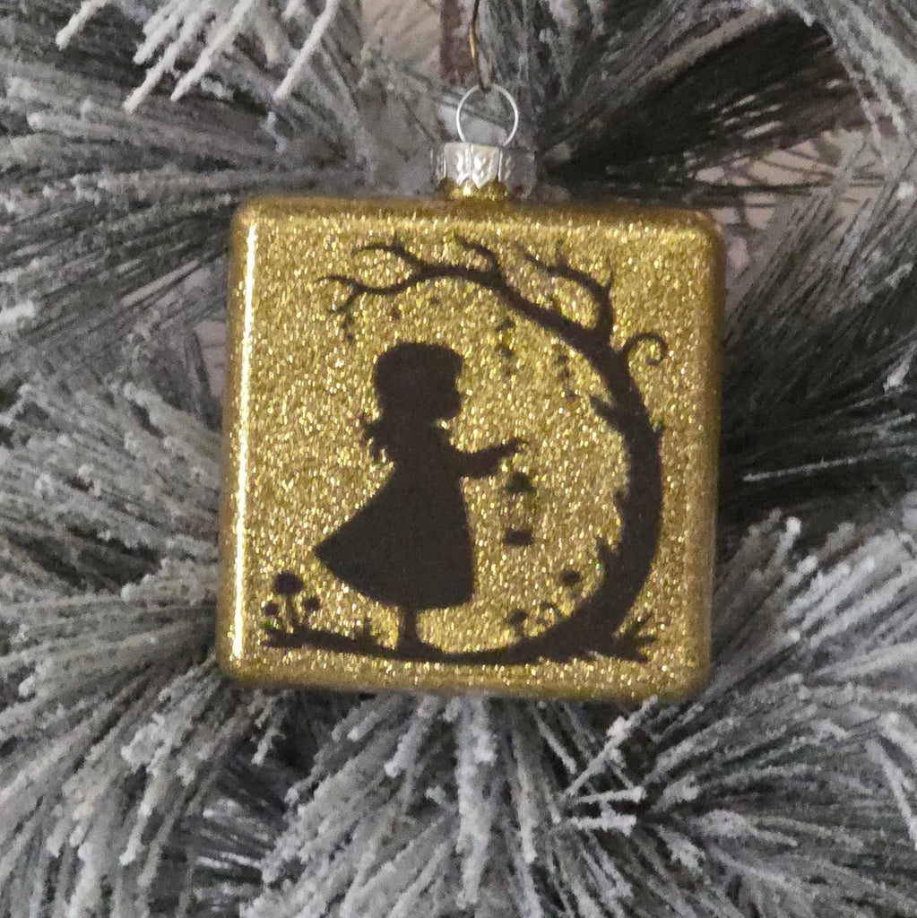 Decorative gold ornament with a black silhouette of girl  with lantern