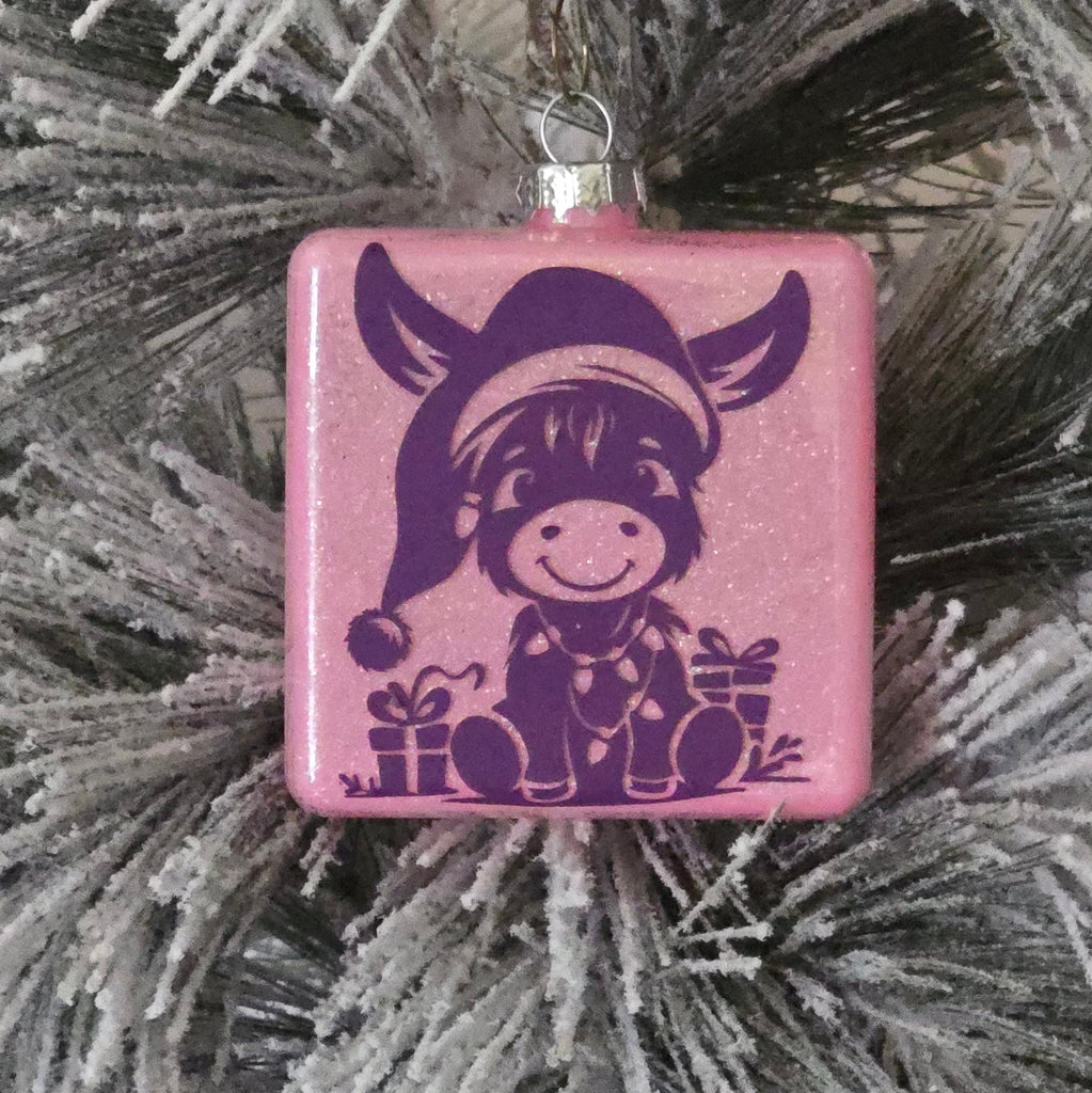 Pink glitter ornament with a purple Xmas donkey  design